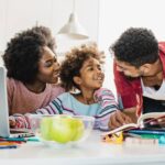 Parents smiling at child in kitchen