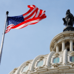 us congress building next to flag