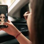 Girl taking selfie in car