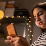 Girl looking at phone while listening to music