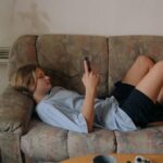 teen texting on couch