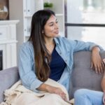 mother and daughter talking on couch