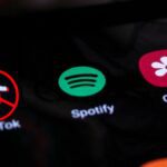 social media icons on phone screen with TikTok banned