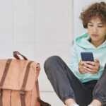 young boy looking at snapchat or instagram on phone