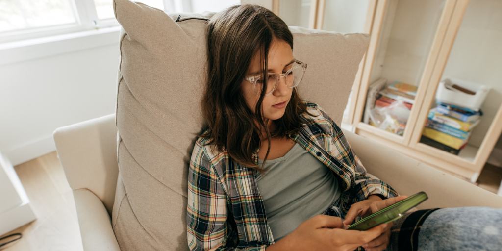 teen girl looking at phone